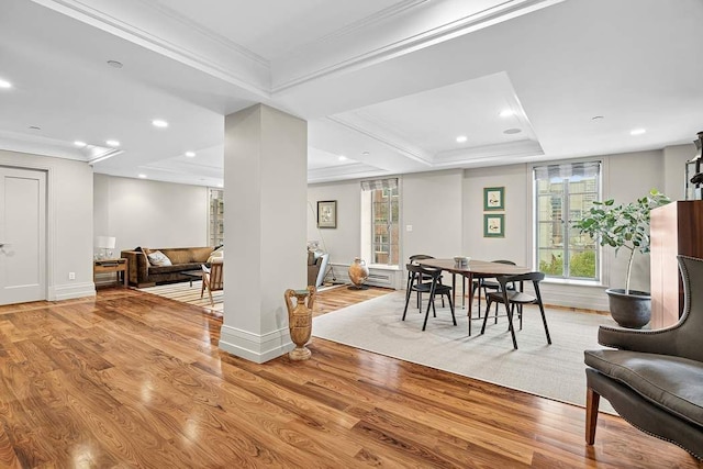 140 E 63rd St Unit 11C, New York City, NY 10065 - dining room with a raised ceiling, ornamental molding, light wood-style floors, recessed lighting, and baseboards