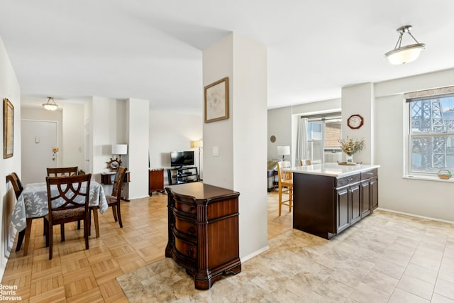 473 Fdr Dr Unit K801, New York City, NY 10002 - kitchen featuring plenty of natural light, dark brown cabinetry, and a breakfast bar area