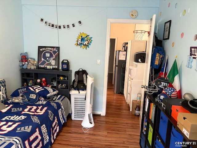2032 W 4th St, New York City, NY 11223 - bedroom with wood finished floors and freestanding refrigerator