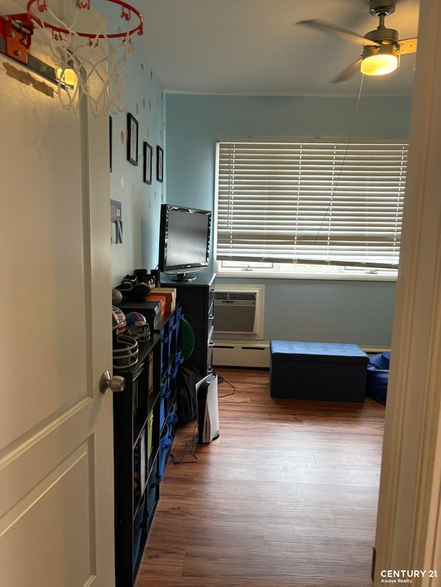 2032 W 4th St, New York City, NY 11223 - office space featuring wood finished floors, a ceiling fan, a baseboard radiator, and a wall unit AC