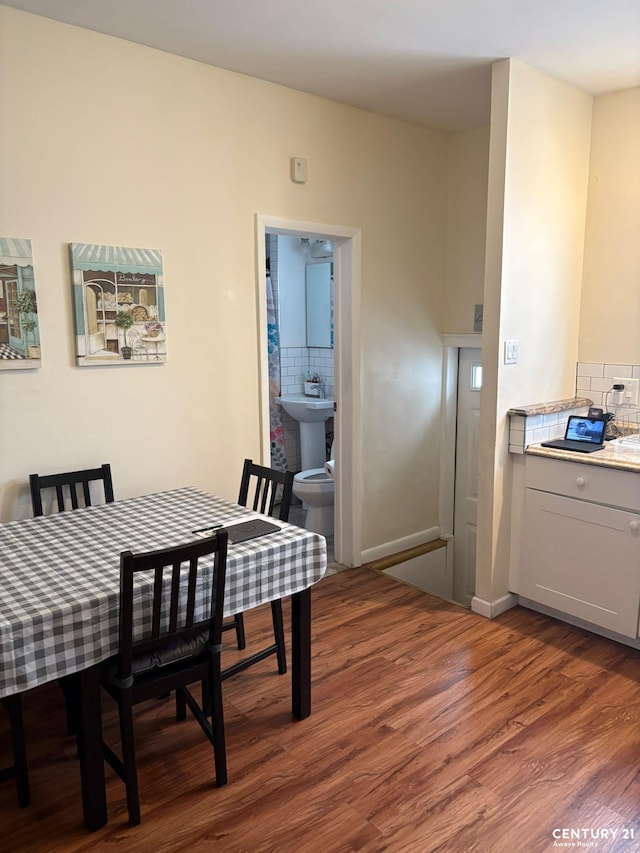 2032 W 4th St, New York City, NY 11223 - dining room featuring wood finished floors and baseboards