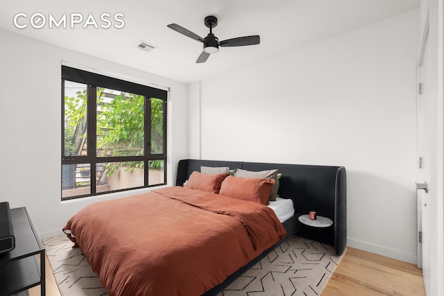 328 Central Ave Unit 1B, New York City, NY 11221 - bedroom with light wood-style flooring, baseboards, and ceiling fan
