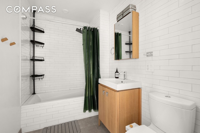 328 Central Ave Unit 1B, New York City, NY 11221 - full bath with toilet, tiled shower / bath combo, vanity, and tile patterned flooring