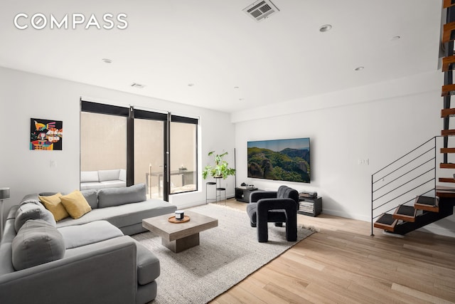 328 Central Ave Unit 1B, New York City, NY 11221 - living room with wood finished floors, stairs, baseboards, and recessed lighting