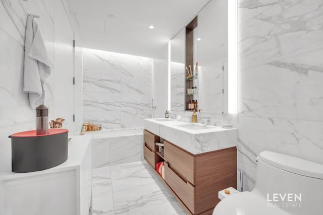 30 Riverside Blvd Unit 22F, New York City, NY 10069 - full bathroom with marble tiled flooring, double vanity, and a garden tub