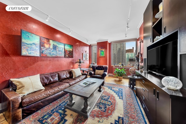 400 E 90th St Unit 8F, New York City, NY 10128 - living area with rail lighting, wood finished floors, and a textured wall
