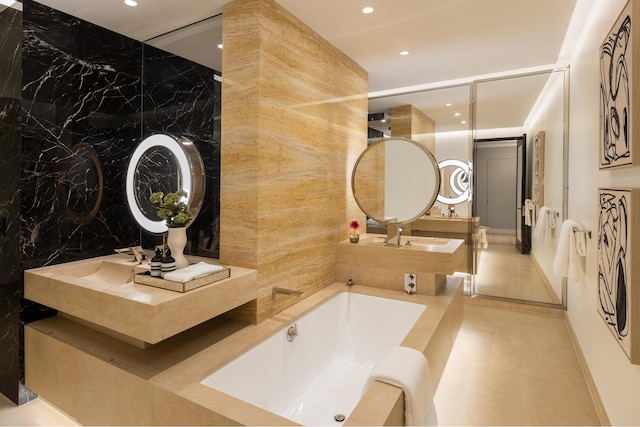 53 W 53rd St Unit 33B, New York City, NY 10019 - bathroom with recessed lighting, a bath, and vanity