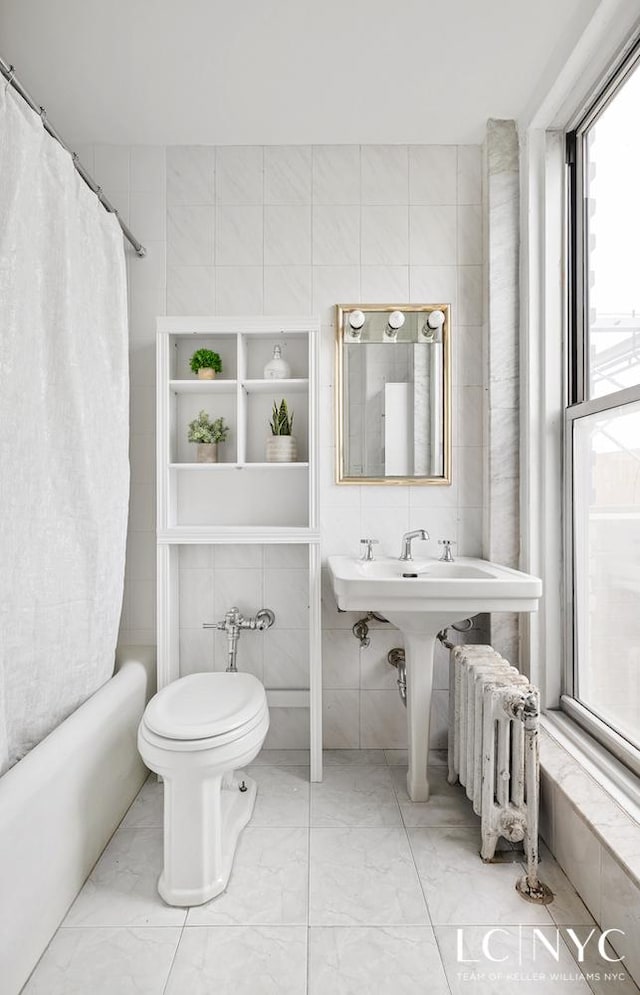 310 Riverside Dr Unit 1804, New York City, NY 10025 - full bathroom featuring tile walls, radiator heating unit, marble look tiles, toilet, and shower / tub combo with curtain