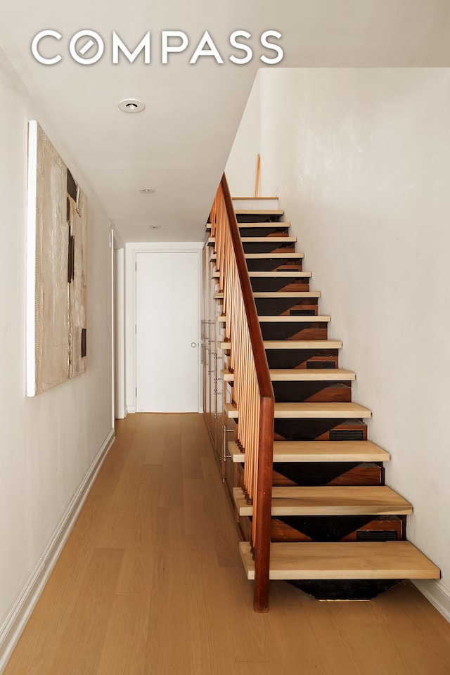 16 Warren St Unit 5, New York City, NY 10007 - staircase featuring wood finished floors and baseboards