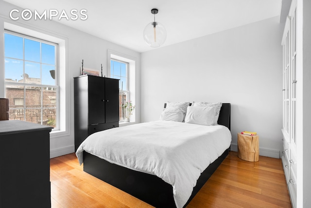 204 W 140th St Unit 4D, New York City, NY 10030 - bedroom with light wood finished floors and baseboards