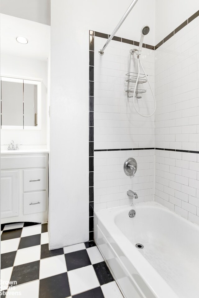 109 Seaman Ave Unit 4A, New York City, NY 10034 - bathroom with tile patterned floors, vanity, bathtub / shower combination, and recessed lighting