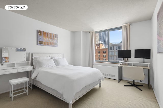 127 E 30th St Unit 11B, New York City, NY 10016 - bedroom featuring light carpet, radiator, and baseboards