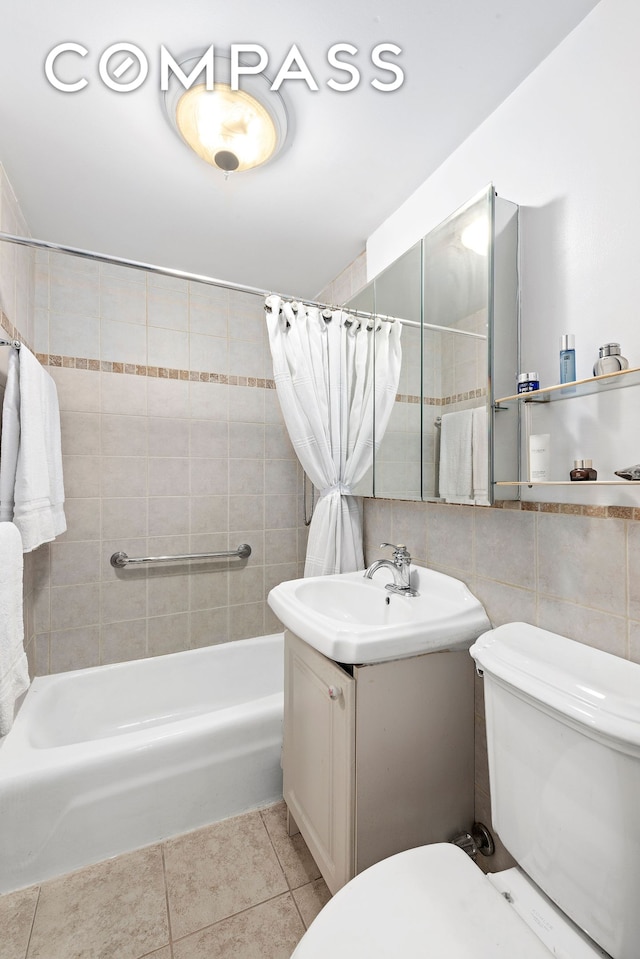 126 E 30th St Unit 1B, New York City, NY 10016 - full bathroom featuring vanity, shower / bath combination with curtain, tile patterned floors, and tile walls