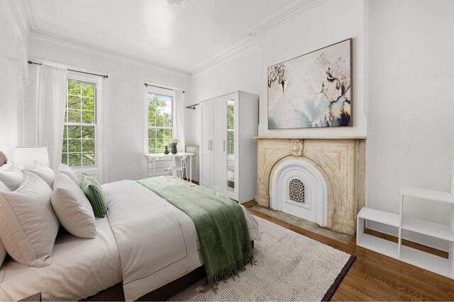 638 Monroe St, New York City, NY 11221 - bedroom featuring ornamental molding and wood finished floors