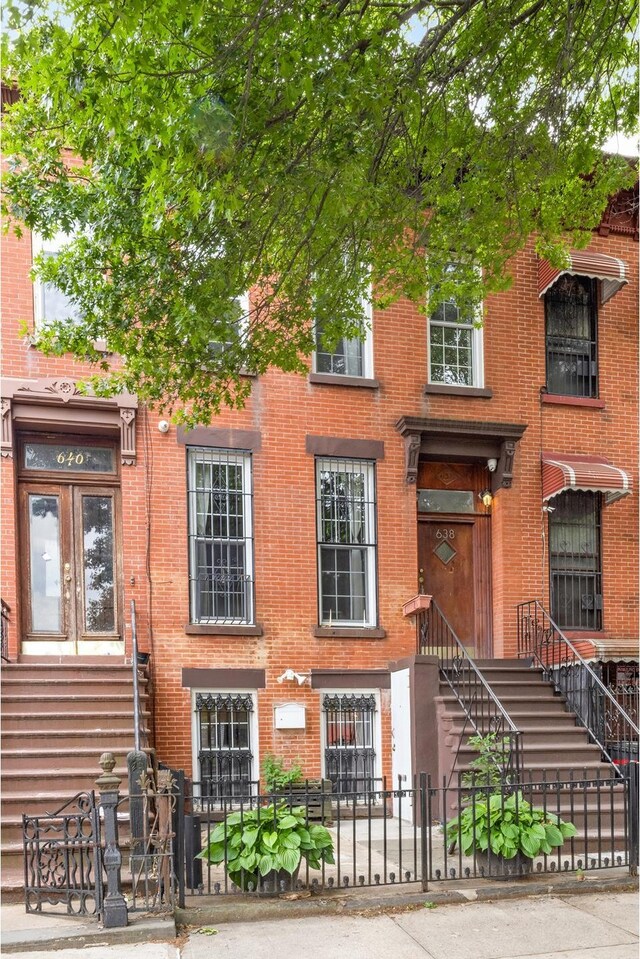 638 Monroe St, New York City, NY 11221 - multi unit property with brick siding and a fenced front yard