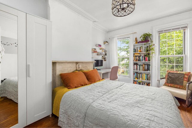 638 Monroe St, New York City, NY 11221 - bedroom with ornamental molding and dark wood finished floors
