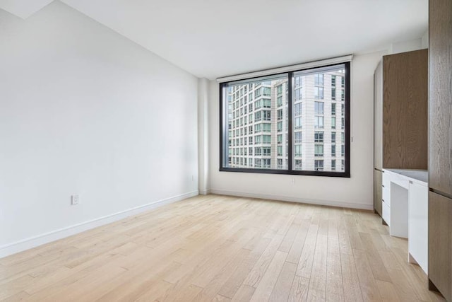 45-30 Pearson St Unit 6F, New York City, NY 11101 - empty room with light wood finished floors and baseboards