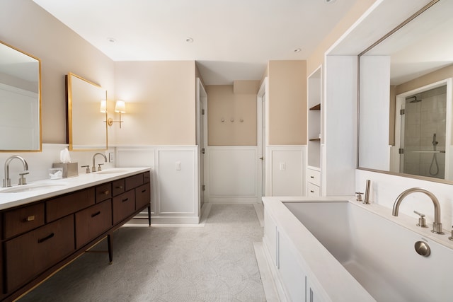 275 W 10th St Unit 5A, New York City, NY 10014 - bathroom featuring double vanity, wainscoting, a decorative wall, and a shower