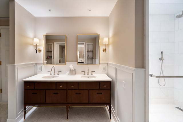 275 W 10th St Unit 5A, New York City, NY 10014 - full bath with a tile shower, double vanity, wainscoting, and a decorative wall