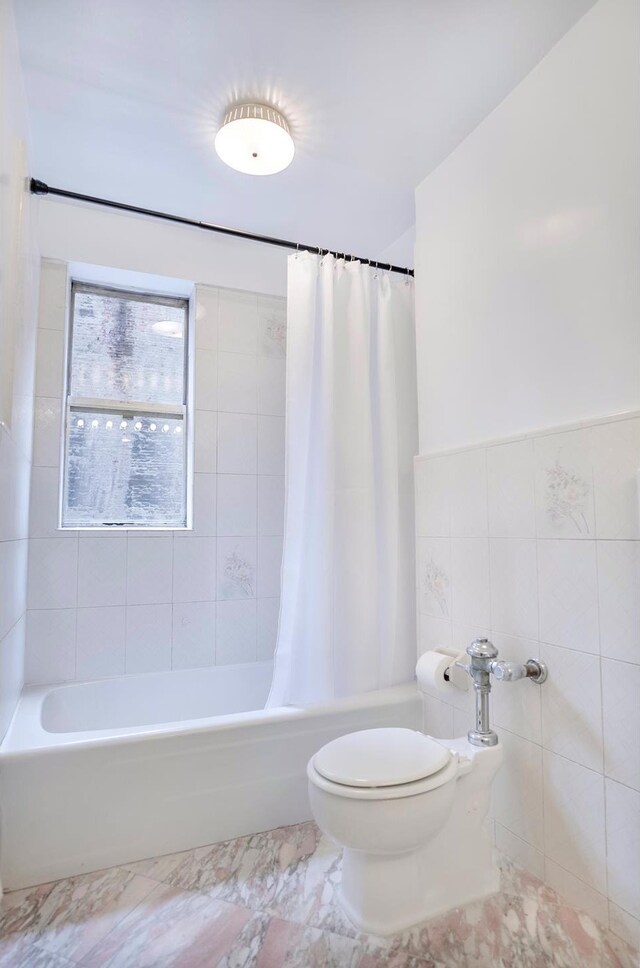 77 W 55th St Unit 4B, New York City, NY 10019 - full bath with shower / bathtub combination with curtain, tile walls, and marble finish flooring