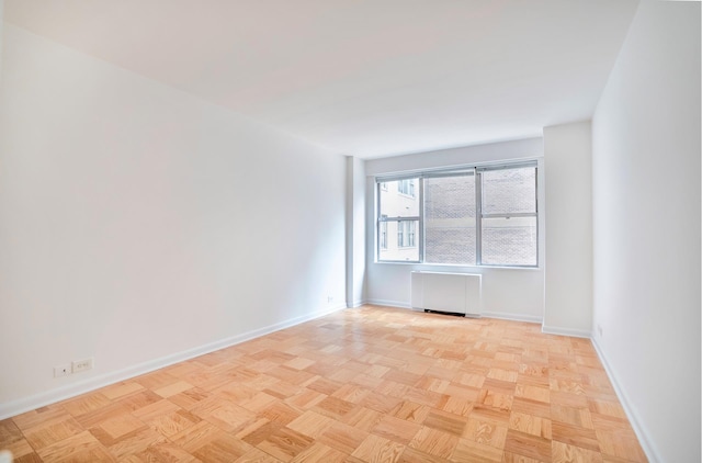 77 W 55th St Unit 4B, New York City, NY 10019 - unfurnished room with radiator and baseboards