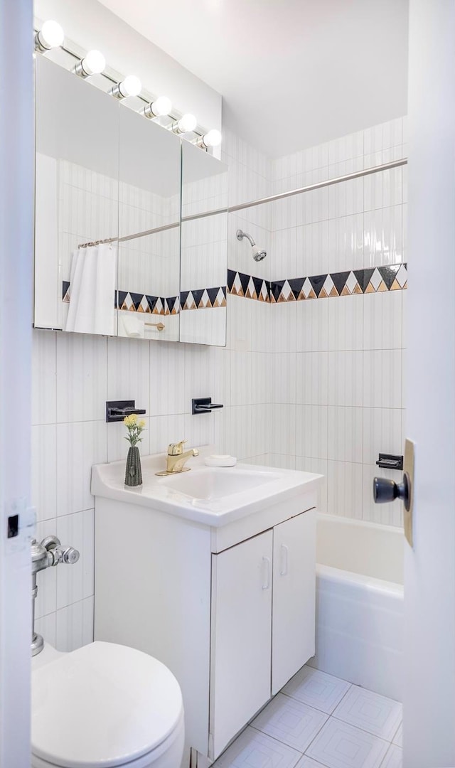 77 W 55th St Unit 4B, New York City, NY 10019 - full bath with vanity, tile walls, shower / tub combo, and tile patterned flooring