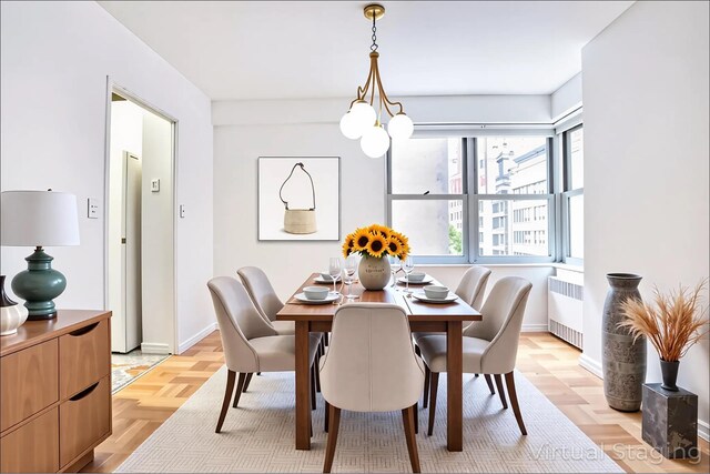 77 W 55th St Unit 4B, New York City, NY 10019 - dining space with radiator heating unit and a chandelier