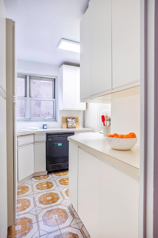 77 W 55th St Unit 4B, New York City, NY 10019 - kitchen with black dishwasher, white cabinetry, light countertops, light tile patterned flooring, and modern cabinets