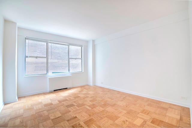 77 W 55th St Unit 4B, New York City, NY 10019 - spare room with baseboards and radiator heating unit