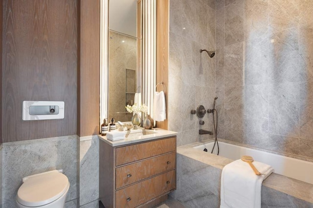 111 W 57th St Unit 57, New York City, NY 10019 - bathroom featuring tile walls, vanity, toilet, and tiled shower / bath