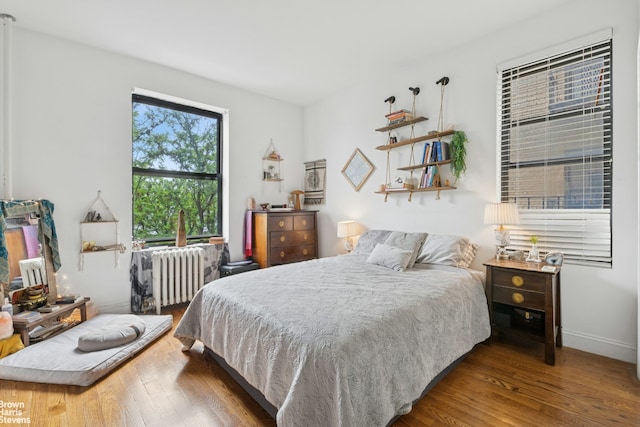 61-09 39th Ave Unit N4, New York City, NY 11377 - bedroom with radiator heating unit, wood finished floors, and baseboards