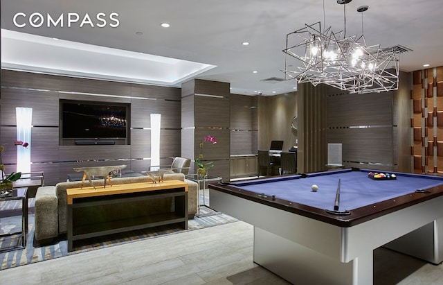 30 W St Unit 25G, New York City, NY 10004 - rec room with recessed lighting, a chandelier, pool table, a tray ceiling, and wood finished floors