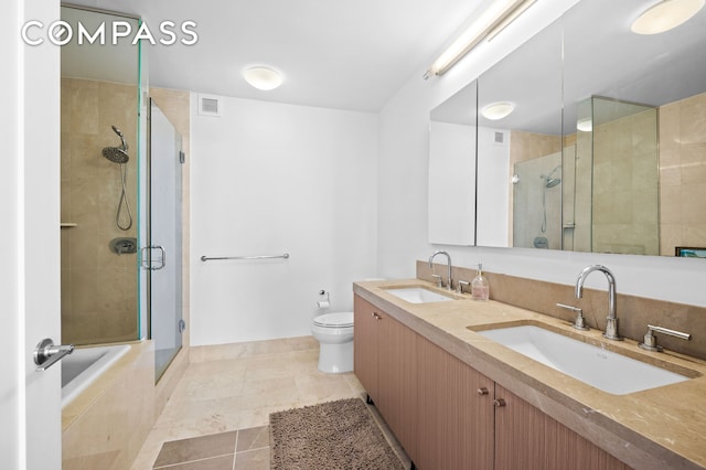 30 W St Unit 25G, New York City, NY 10004 - bathroom featuring a stall shower, toilet, double vanity, tile patterned floors, and a relaxing tiled tub