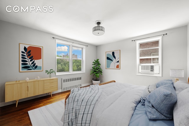 180 Van Cortlandt Park S Unit 4C, New York City, NY 10463 - bedroom with radiator, dark wood-style flooring, and baseboards