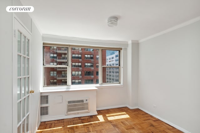 233 E 70th St Unit 8T, New York City, NY 10021 - spare room featuring a wall mounted air conditioner, ornamental molding, and baseboards