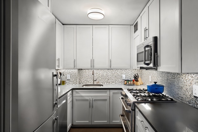 201 W 70th St Unit 15G, New York City, NY 10023 - kitchen with stainless steel appliances, tasteful backsplash, and white cabinets