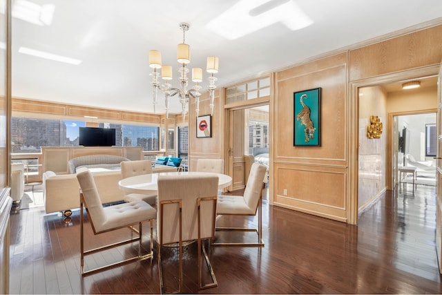 721 5th Ave Unit 39A, New York City, NY 10022 - dining space featuring a decorative wall, dark wood finished floors, and a chandelier