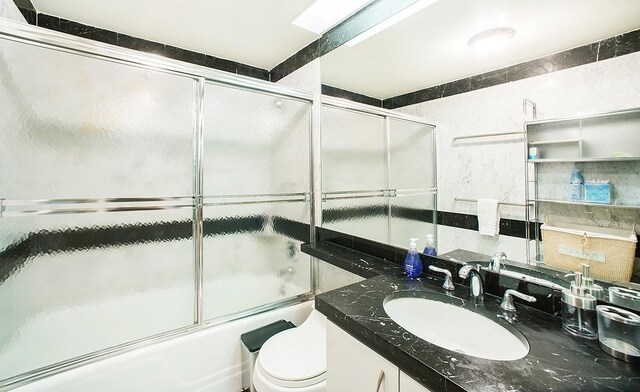 150 W 56th St Unit 3104, New York City, NY 10019 - full bathroom with vanity, toilet, and shower / bath combination with glass door