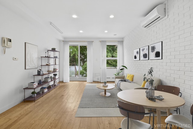142 Skillman Ave Unit 2B, New York City, NY 11211 - living room featuring an AC wall unit, light wood-type flooring, recessed lighting, a baseboard heating unit, and brick wall