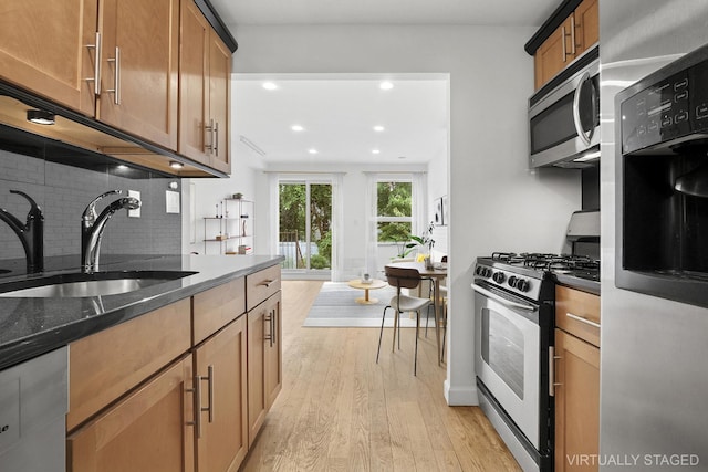 142 Skillman Ave Unit 2B, New York City, NY 11211 - kitchen with stainless steel appliances, a sink, recessed lighting, light wood-type flooring, and decorative backsplash