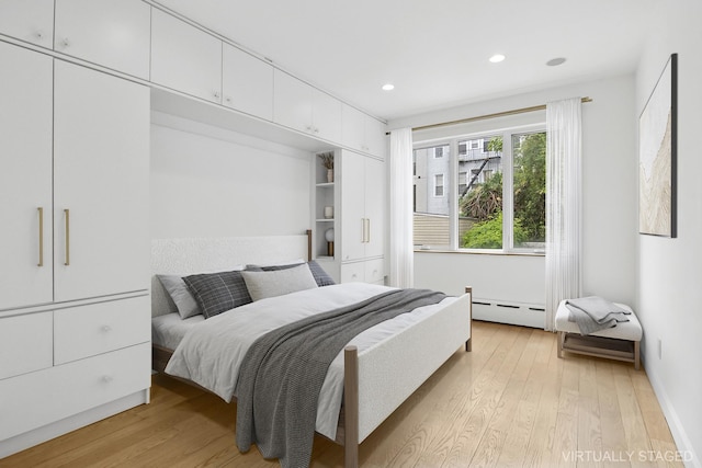 142 Skillman Ave Unit 2B, New York City, NY 11211 - bedroom with a baseboard heating unit, light wood-type flooring, and recessed lighting