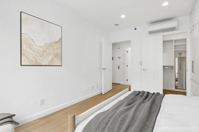 142 Skillman Ave Unit 2B, New York City, NY 11211 - bedroom with a wall mounted air conditioner, wood finished floors, recessed lighting, and baseboards