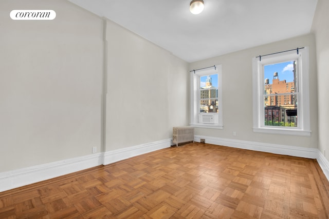 226 E 27th St Unit 5C, New York City, NY 10016 - unfurnished room featuring radiator heating unit, baseboards, and a view of city