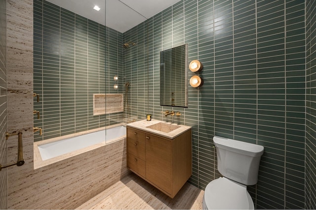 155 W 11th St Unit 4G, New York City, NY 10011 - bathroom featuring tile walls, vanity, tiled shower / bath combo, and wood finished floors