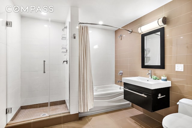 105 Lexington Ave Unit 2E, New York City, NY 11238 - bathroom with toilet, vanity, shower / bath combination with glass door, tile patterned flooring, and tile walls