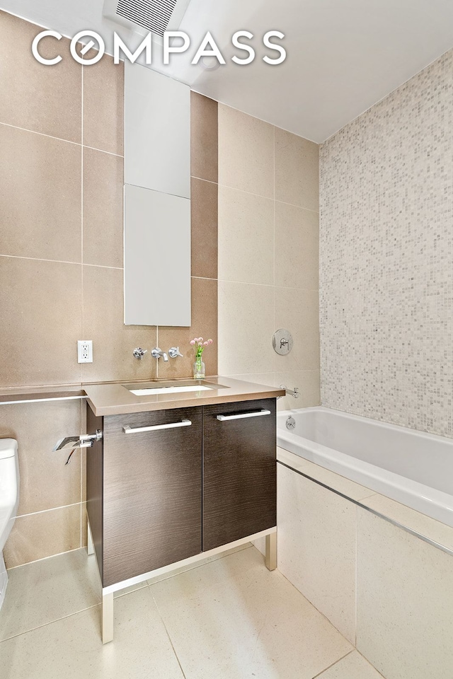 309 2nd St Unit 2F, New York City, NY 11215 - bathroom with tile walls, vanity, and toilet