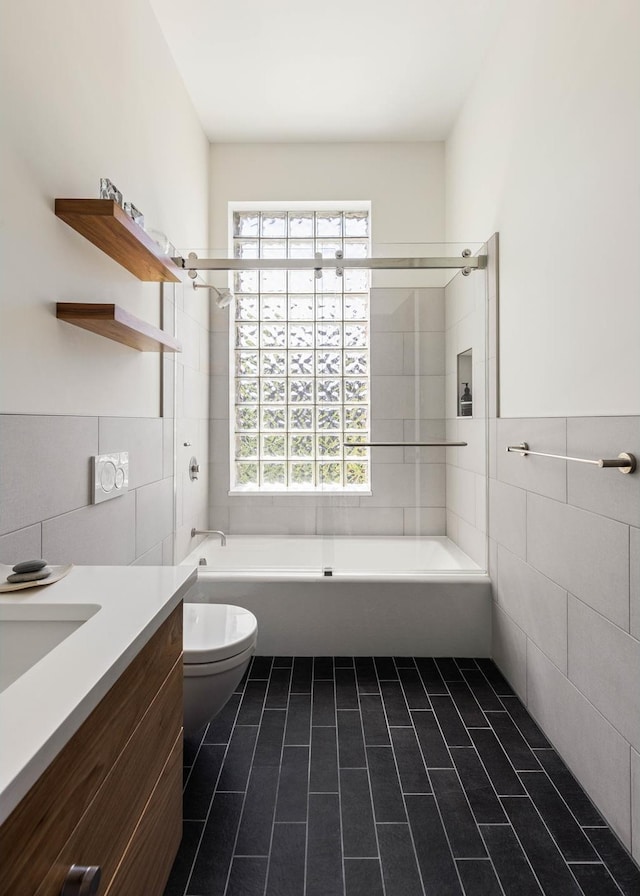 208 Garfield Place, New York City, NY 11215 - bathroom with tile walls, vanity, washtub / shower combination, and tile patterned floors
