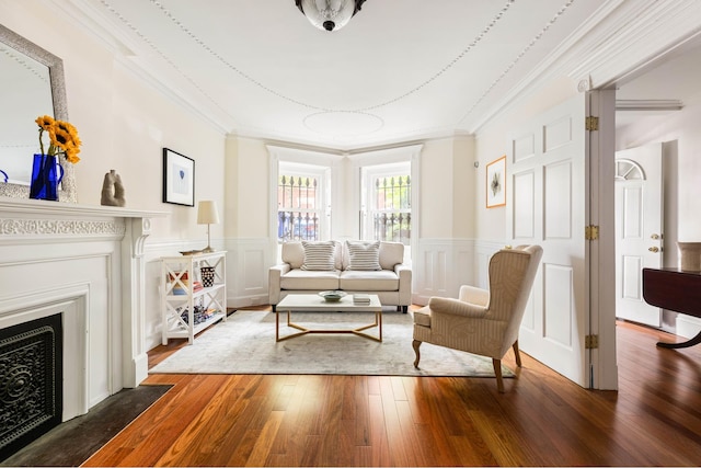 208 Garfield Place, New York City, NY 11215 - living room with crown molding, wood-type flooring, a fireplace with flush hearth, a decorative wall, and wainscoting