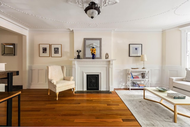 208 Garfield Place, New York City, NY 11215 - living room featuring a fireplace with flush hearth, wood finished floors, ornamental molding, a wainscoted wall, and a decorative wall