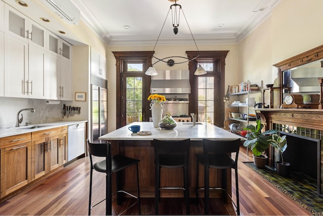 208 Garfield Place, New York City, NY 11215 - kitchen with white dishwasher, dark wood finished floors, a breakfast bar, white cabinets, and glass insert cabinets